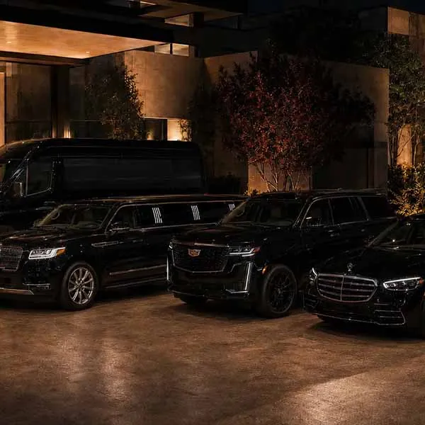 Variety of Boston limo time luxury vehicles parked in a client's beautiful home